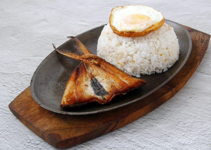 Freshly cooked Filipino food called Bangsilog or fried bangus or milkfish, egg and fried rice