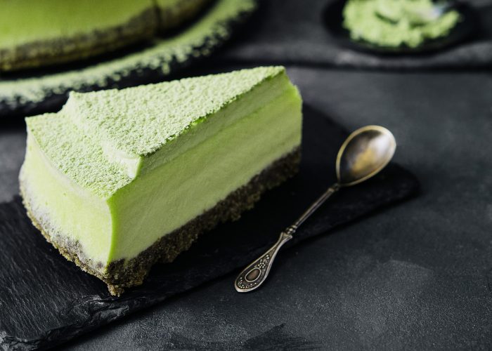 Matcha cheesecake on stone close up